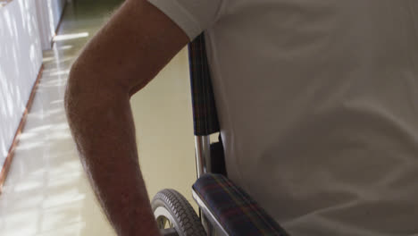 senior man in social distancing in a corridor of retirement house