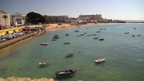 Beautiful-harbor-in-Cadiz,-Spain-with-fishing-boats-and-beach