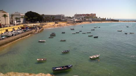 beautiful harbor in cadiz, spain with fishing boats and beach