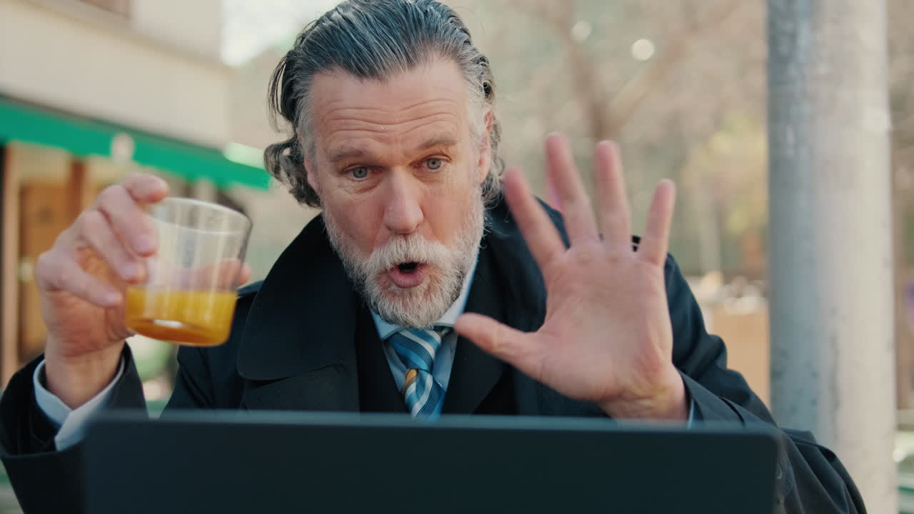 Businessman Video Chat at Outdoor Cafe