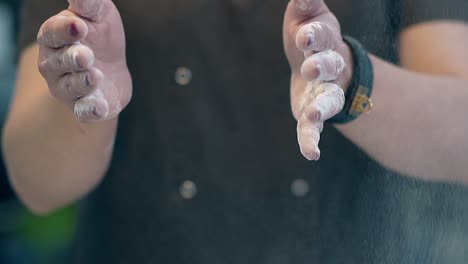 woman-accurately-claps-hands-stained-with-flour-makes-dust