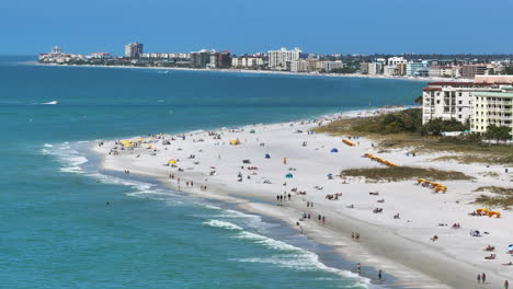 aerial long view of a beautiful florida beach vista with people walking