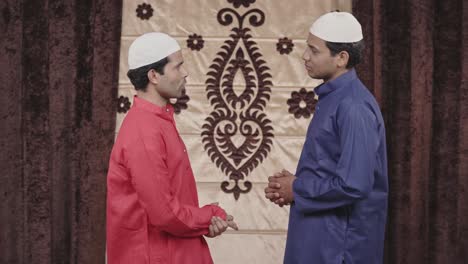 two sad muslim men talking to each other