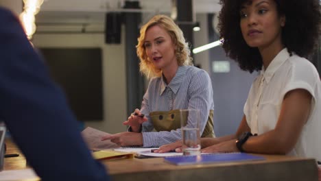 diverse group of business colleagues talking in a meeting room