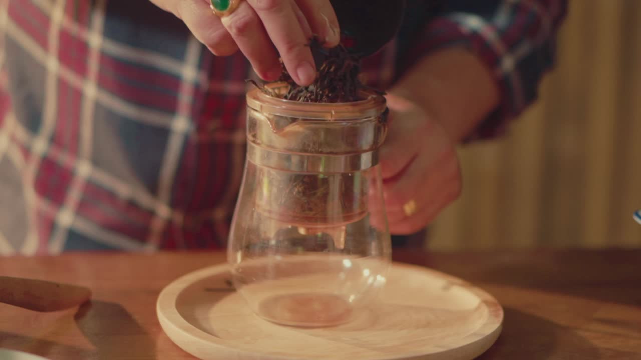 Hand Selecting Dried Tea Leaves for Brewing with Glass Tea Press