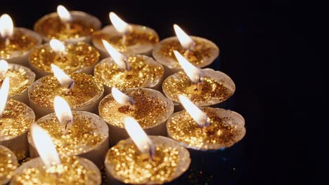 Background-of-tea-cup-glitter-Candles-Lights-shines-yellow-gold-bright-for-celebration,-religion,-anniversary-Festival
