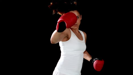 brunette punching in boxing gloves