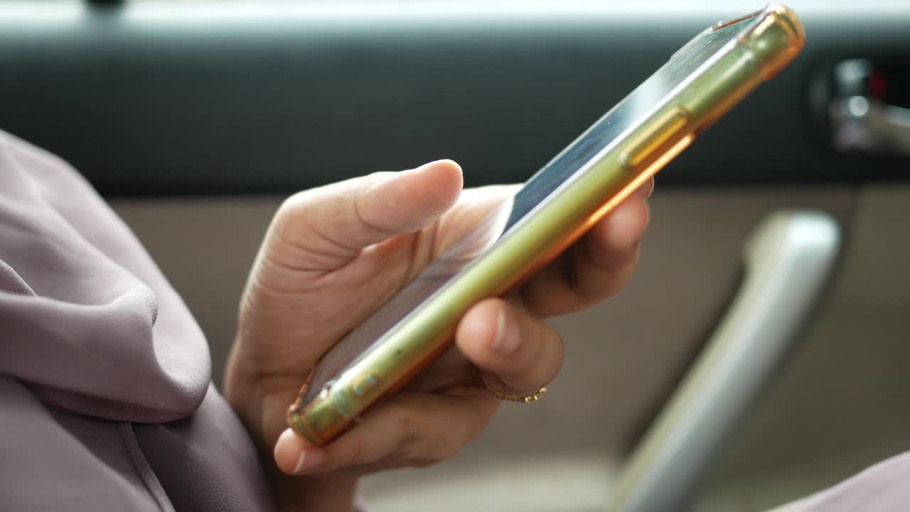 mujer usando un teléfono inteligente en un coche