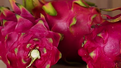 dragon fruits arranged on a wooden surface