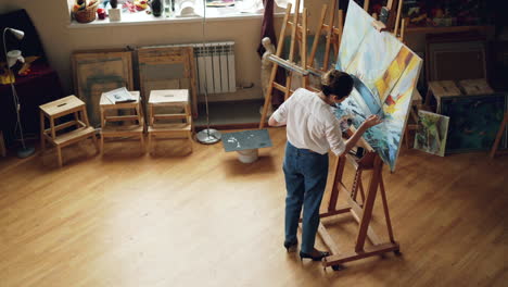 woman artist painting in studio