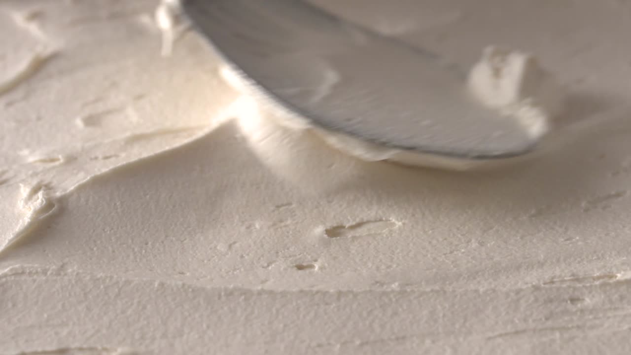 용기 안의 신선한 아이스크림 표면을 숟가락으로 문지릅니다.