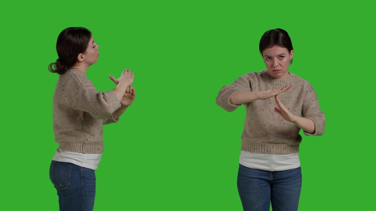 Woman on green screen gesturing a time out sign