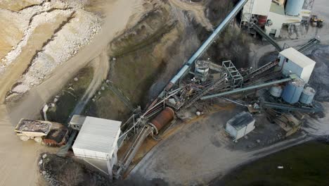 at a german limestone quarry and lime processing plant, a rock truck dumbs into the feeder of a conveyor system