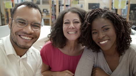 smiling people making video call at library