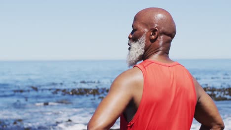 Senior-african-american-man-exercising-looking-at-the-sea