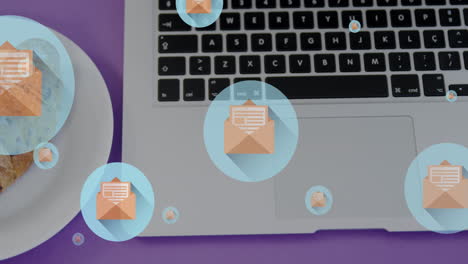 animation of letter in open envelope icons, overhead view of laptop and croissants in plate