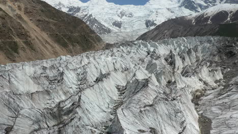 Drone-shot-of-descending-toward-glacier-canyons-with-Nanga-Parbat-in-the-background,-Fairy-Meadows-Pakistan,-cinematic-aerial-shot