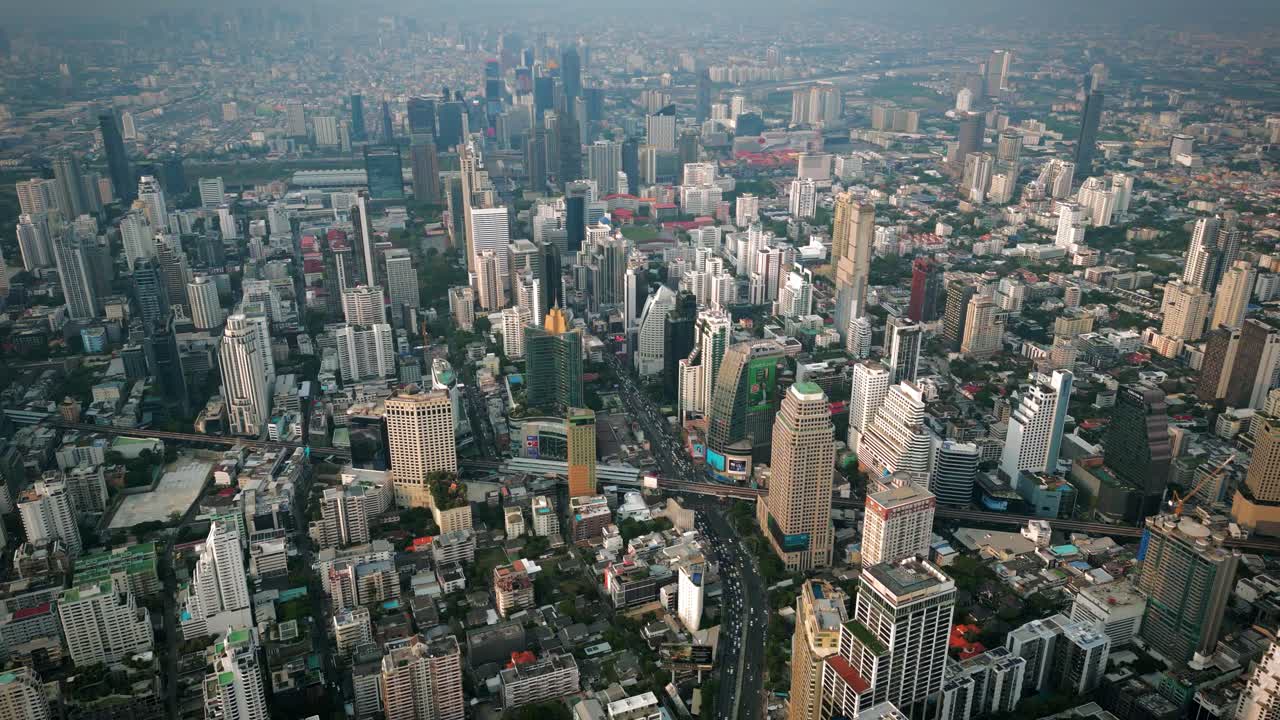 Aerial Scenic Drone Footage of the Skyline of Downtown Bangkok, Thailand Covered in Smog during Sunset during the Smokey Burning Season