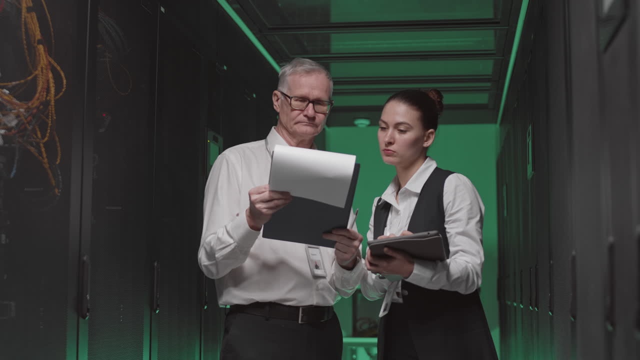 Technicians Inspecting Servers in a Data Center