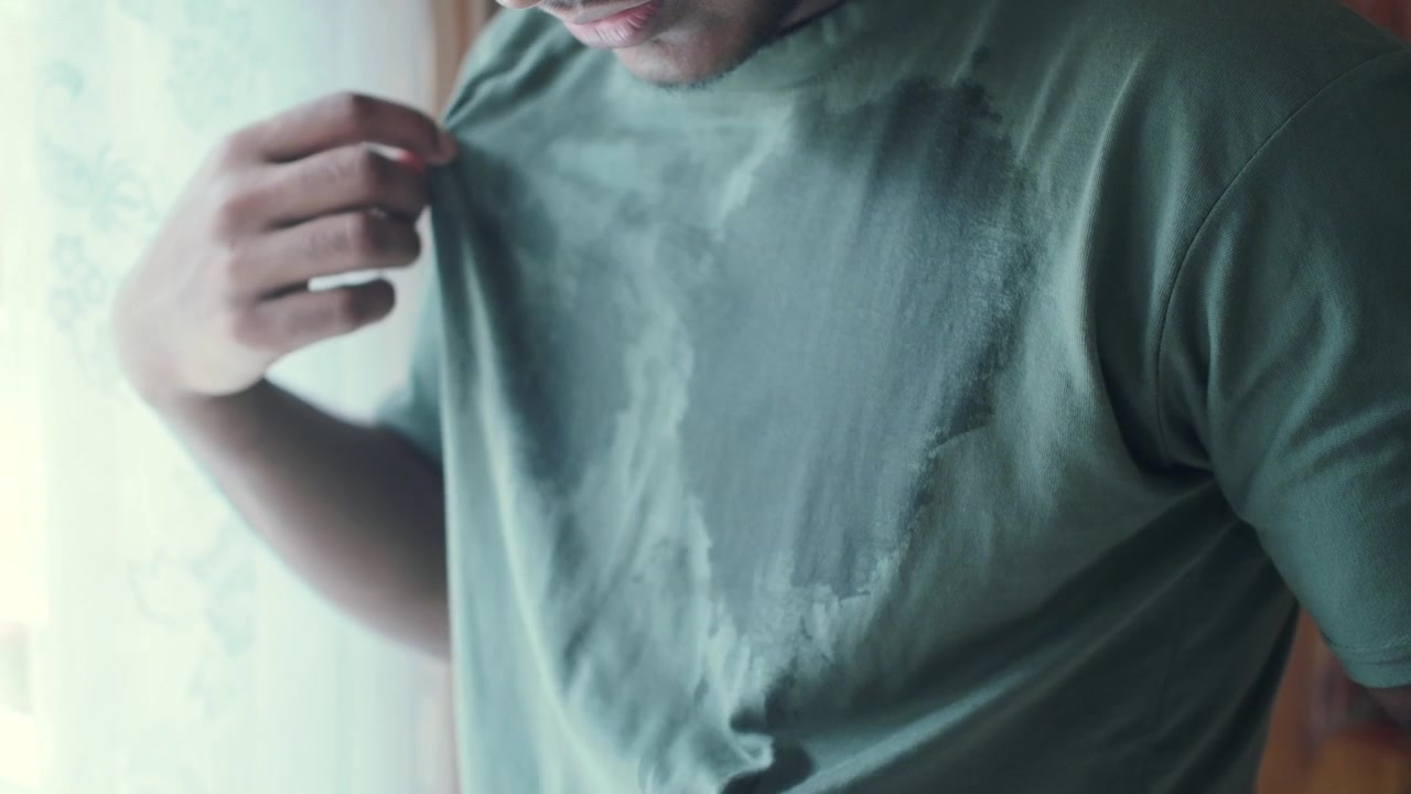 Man Wearing Sweat-Stained T-Shirt in Hot Environment