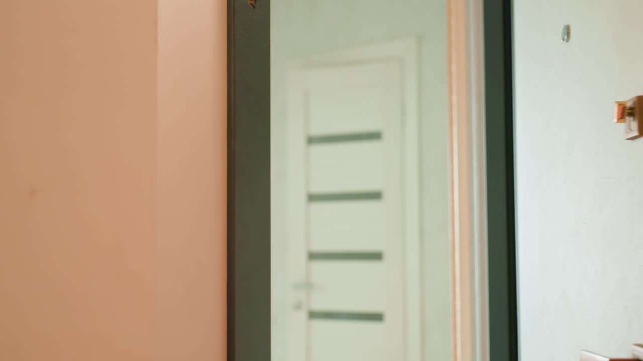 Back View Of Lady Moving Through Hallway, Woman Carrying Shoulder Bag Strolls Within Warmly Lit Corridor, Female Individual With Shoulder Bag Sketches Path Through Softly Illuminated Hallway