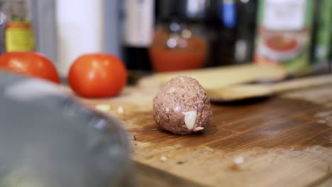 rolling meatballs from scratch and putting them on cutting board preparing ingredients to make vegan beyond meatballs with spaghetti and meat sauce