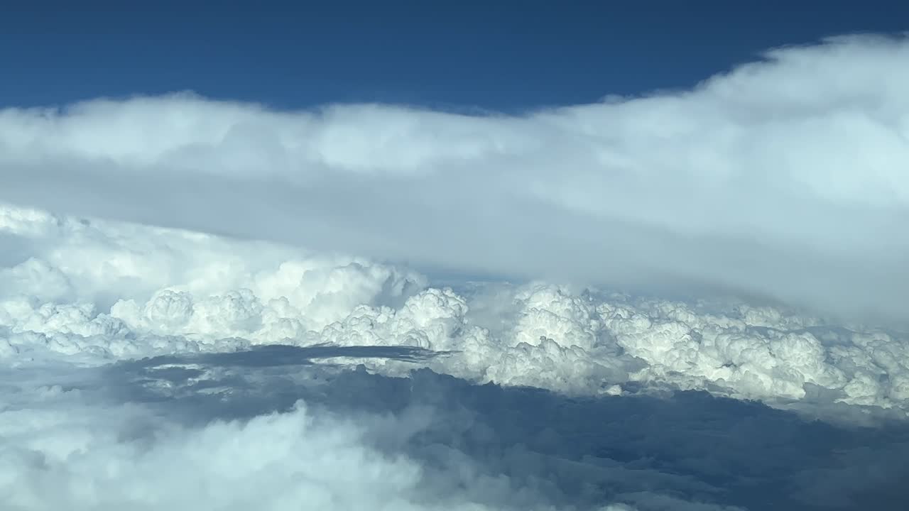A pilot&rsquo;s point of view: flying across a turbulent sky plenty of storm clouds at 12000m high, looking for a gap to avoid