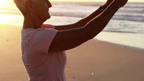 Smiling-senior-woman-taking-selfie-on-mobile-phone