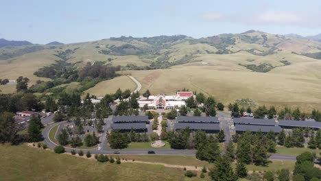 aerial descending close-up shot of the hearst castle visitor center in san simeon, california