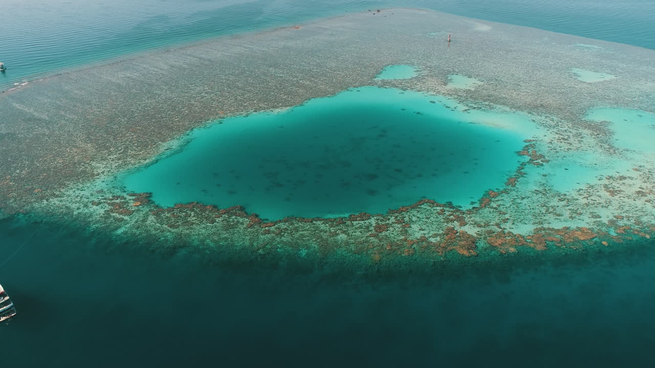 Aerial Shot for the Red Sea of Egypt in the North beside Hurghada with the drone moving forward towards a light house on a coral island of Abu Nuhas Coral island