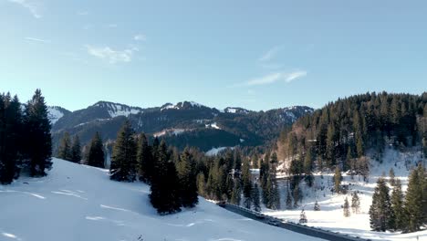 Captivating-Aerial-Drone-View-of-Winter-Mountains-in-Bavarian-Alps,-Germany:-Snow-Blanketed-Landscape-near-Spitzingsee-Lake,-Alpine-Majesty-from-Above