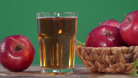 fresh apple juice in the glass rotates.