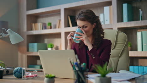 calm employee drinking coffee in morning office. smiling business manager rest