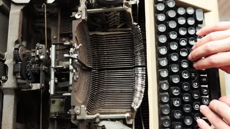 Top-View-Of-A-Person-Typing-On-Old-And-Rusty-Manual-Typewriter