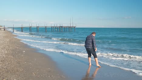 man walking on the beach