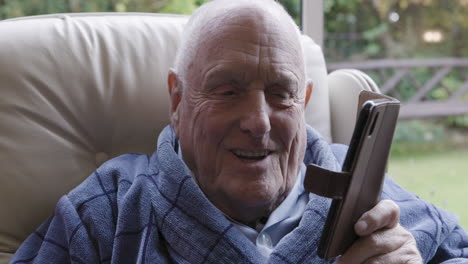 elderly man relaxing with a phone