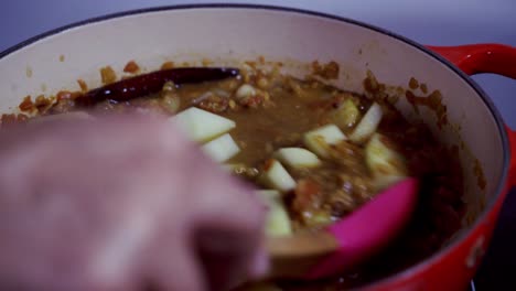 Adding-water-to-a-papaya-curry-dish-Green-and-ripe-yellow-organic-fresh-papaya-pawpaw