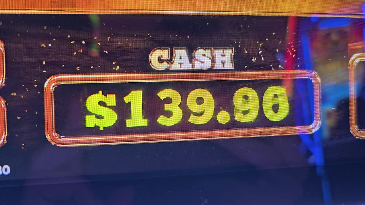 Casino slot machine bonus screen with bright credits total, colorful confetti, yellow and orange lights, glossy display, and arcade style graphics for gambling and jackpot videos.