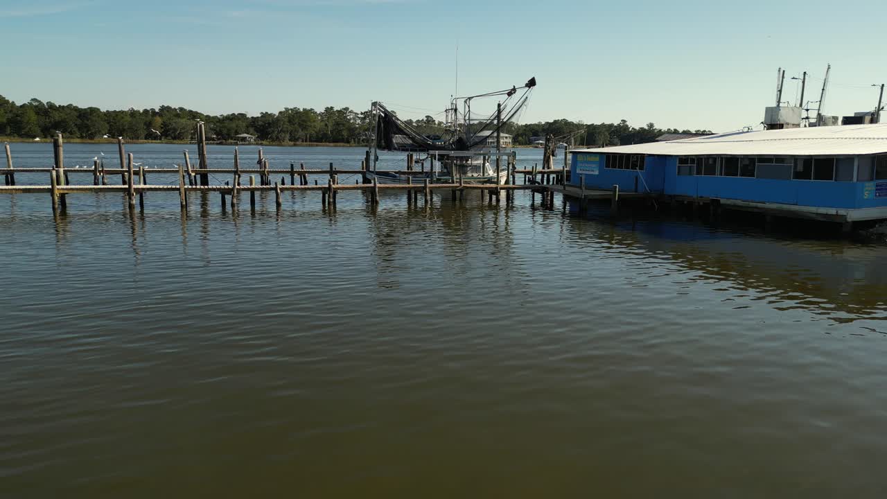 Aerial reverse view of commercial boat and dock in Alabama