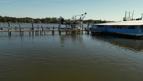 Aerial-reverse-view-of-commercial-boat-and-dock-in-Alabama