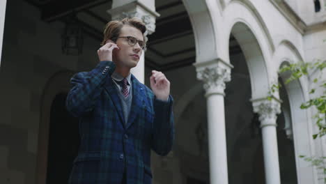 student using wireless earphones outdoors