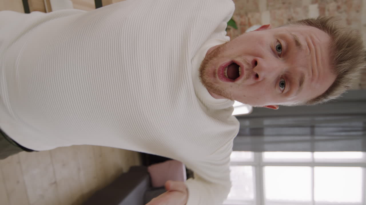 Vertical Shot of Man Dancing and Looking at Camera