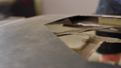 close up hand using grinding disc on metal sheet with sparks flying, 4k