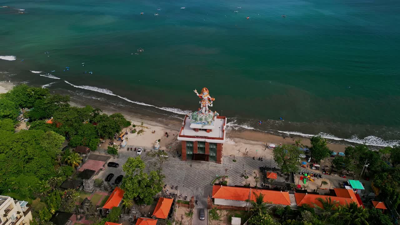 Drone view captures the towering tsunami shelter with the Baruna statue atop, blending practical design for disaster safety with intricate traditional sculpture work