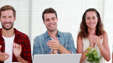 Casual-business-team-applauding-during-meeting