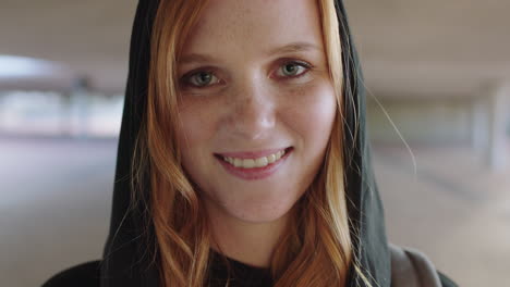 close-up-portrait-of-beautiful-young-redhead-woman-smiling-gentle-looking-at-camera-wearing-hoodie