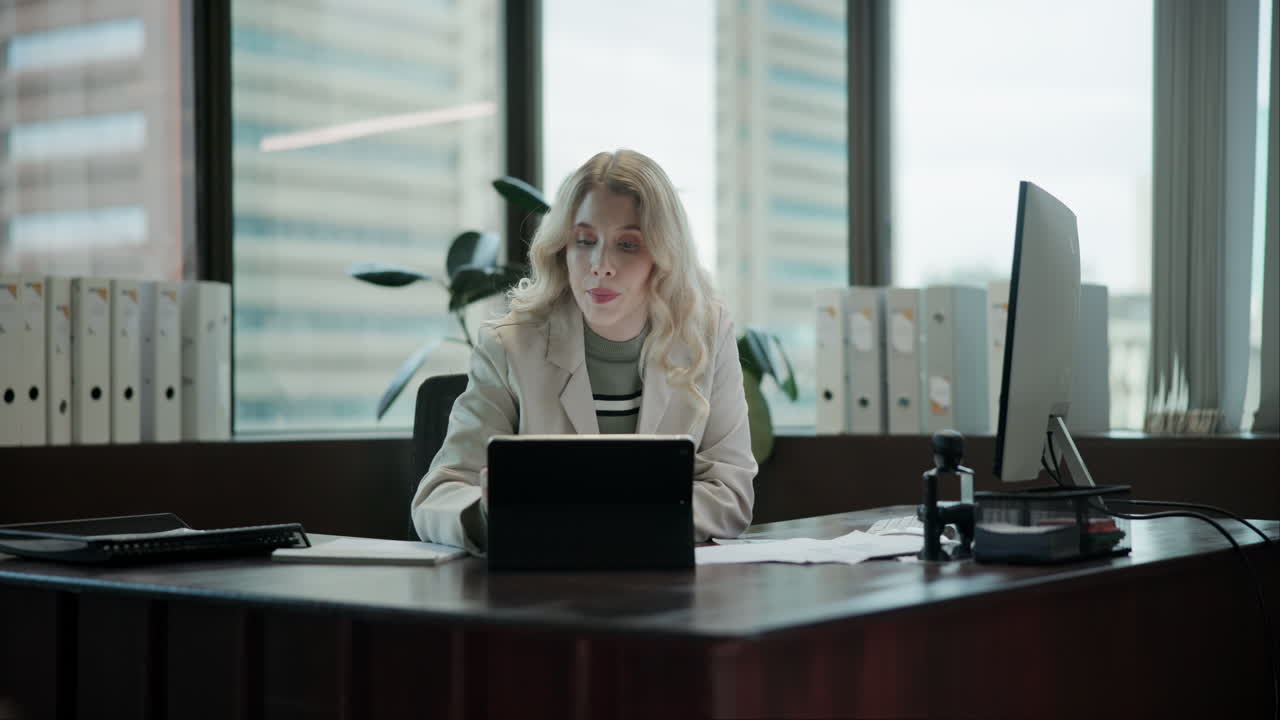 A woman working at a desk in an office
