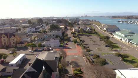 old historic victorian houses in downtown eureka next to waterfront, drone backwards