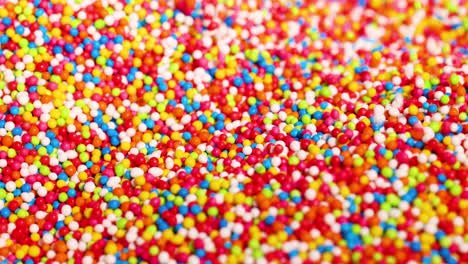 hands playing with vibrant, colorful sprinkles