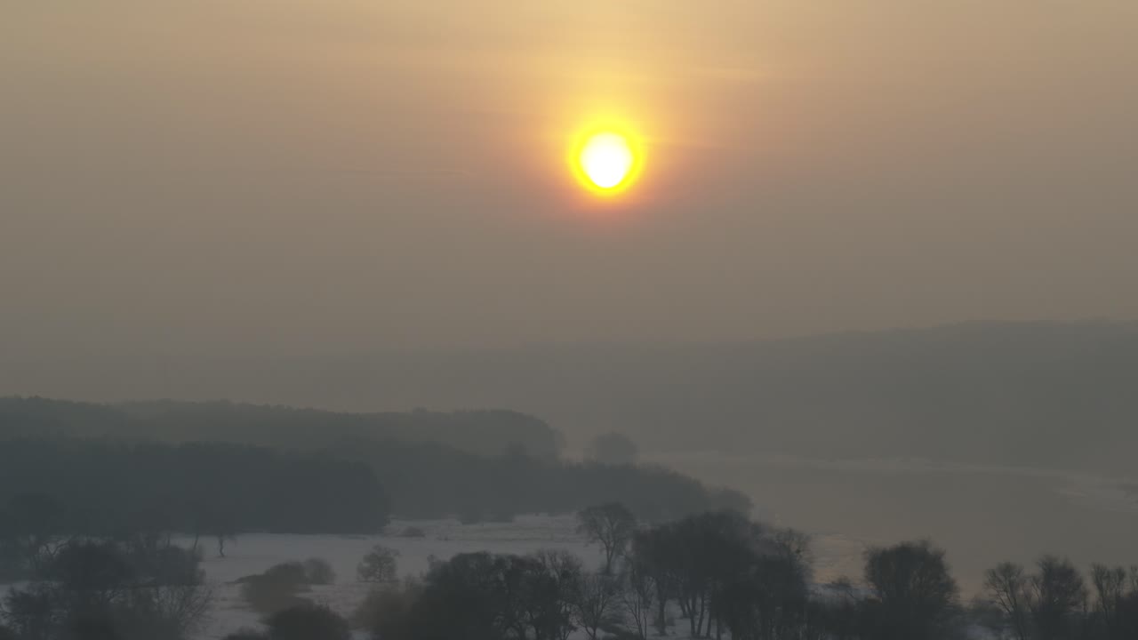 Aerial view of Lithuania nature in a misty sunrise. Cold winter morning